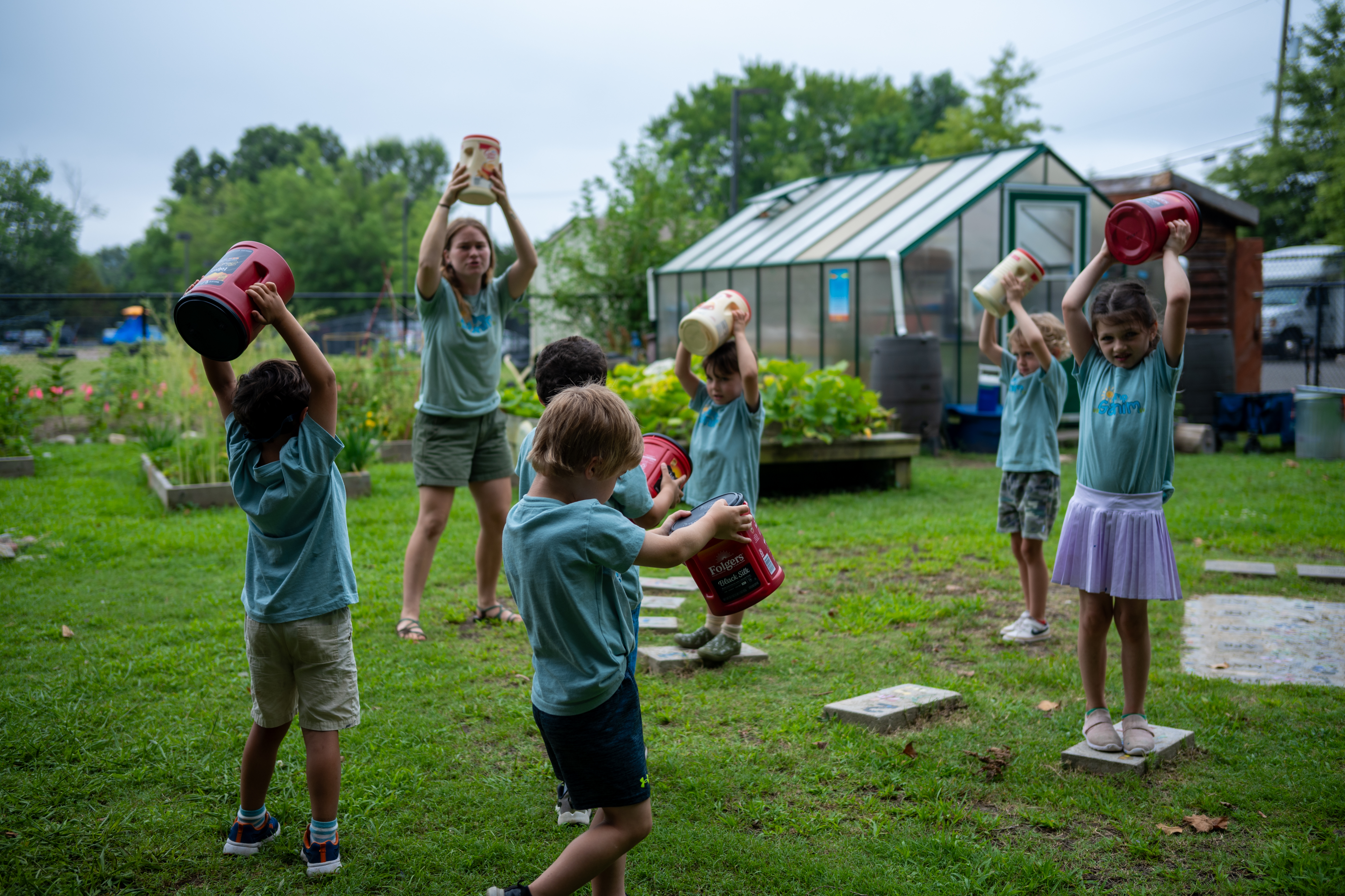 shaking containers to make art with teacher